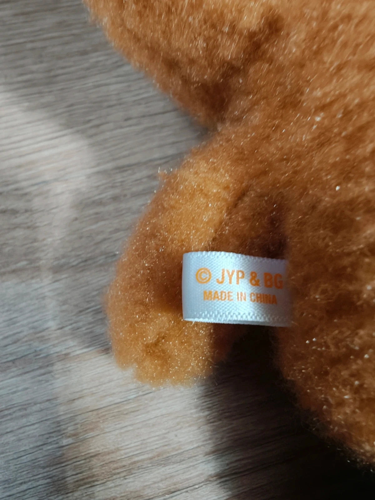 Stray Kids Run It Merch Cross Body Bag Han Quokka SKZOO, close-up of the fabric label