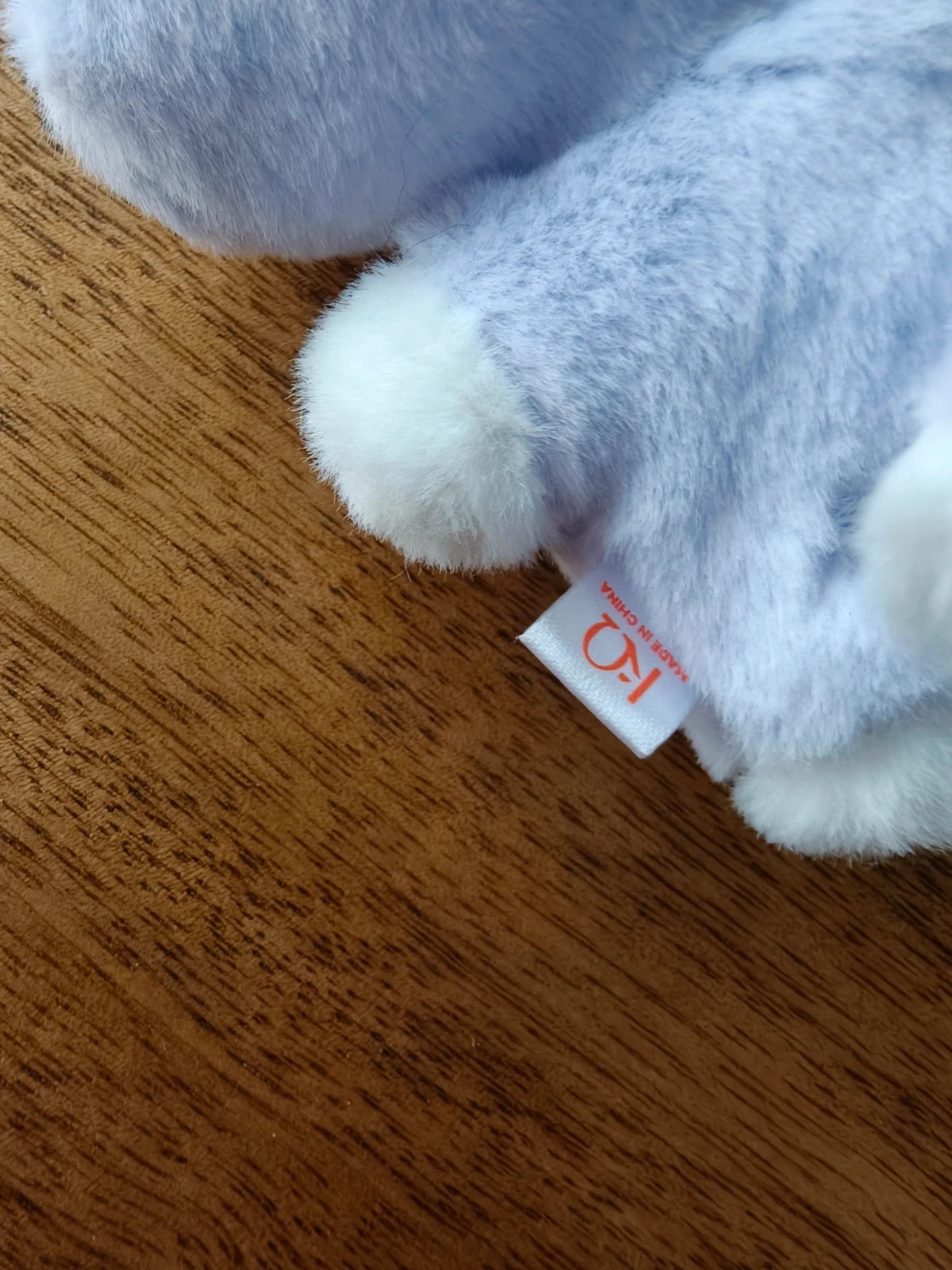 ATEEZ Aniteez Sandeoki Plush Flat Fur San, close-up of plush tail and fabric label