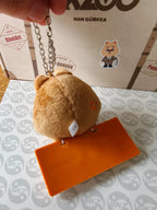 Stray Kids SKZOO HAN QUOKKA Name Bag Charm (TOY WORLD), angled view of the charm, chain and orange plate