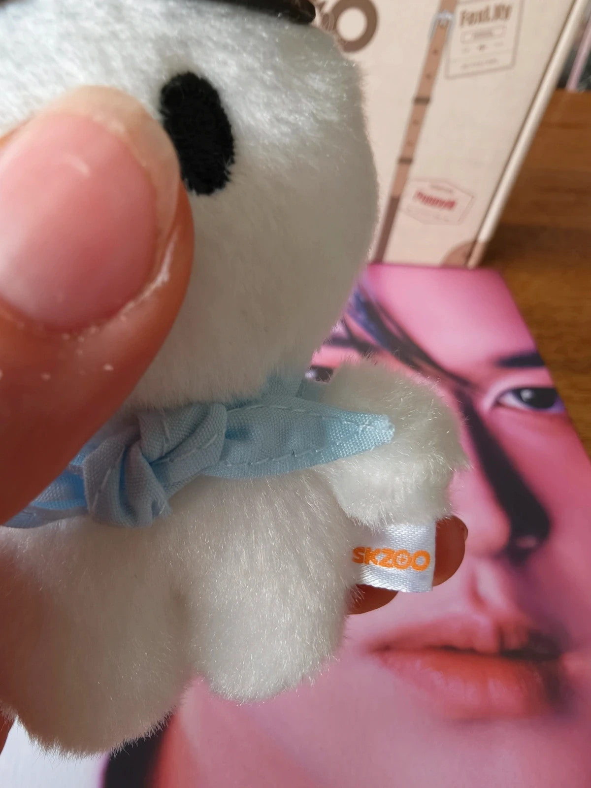 Stray Kids SKZOO Leebit Plush (PILOT), close-up of the blue scarf and fabric label