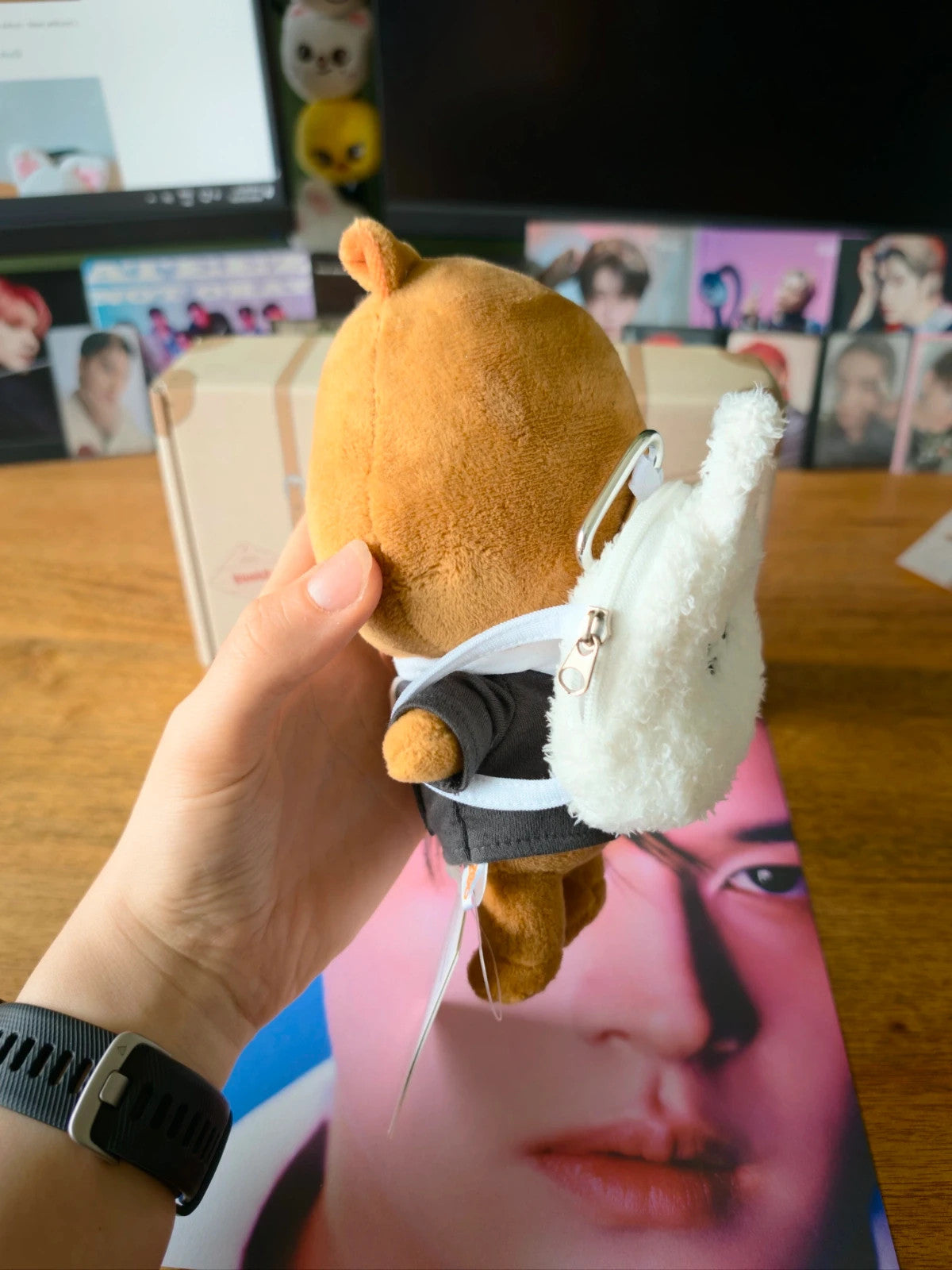 Stray Kids SKZOO Leebit Mini Backpack, side view of the backpack displayed on a plush