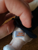 Stray Kids SKZOO FoxI.Ny Plush (Victory), close-up of the fabric label under the black shirt