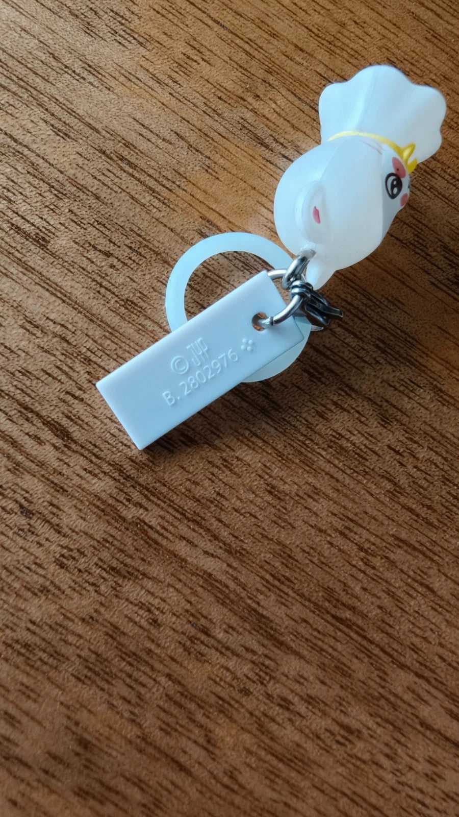 Stray Kids SKZOO Jiniret Figure Keyring, back of the white figure keyring and strap
