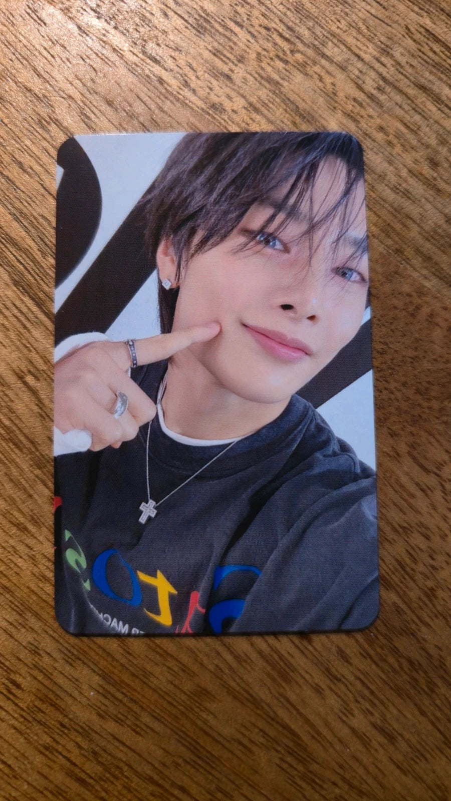 Stray Kids dominATE Celebrate Photocard I.N, portrait with dark hair and finger-to-cheek pose