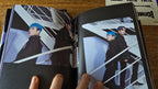 ATEEZ THE WORLD EP.2 : OUTLAW Album, open photobook showing portraits in dark outfits