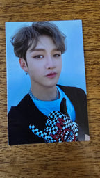 Stray Kids Levanter Photocard Bang Chan, portrait in a black top against a blue background