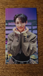 Stray Kids The Sound Photocard Felix, portrait with hands beneath chin against a purple background