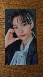 Stray Kids The Sound Photocard Felix, portrait in a pale blue shirt with hand by cheek