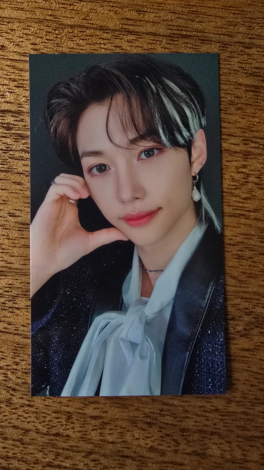 Stray Kids The Sound Photocard Felix, portrait in a pale blue shirt with hand by cheek