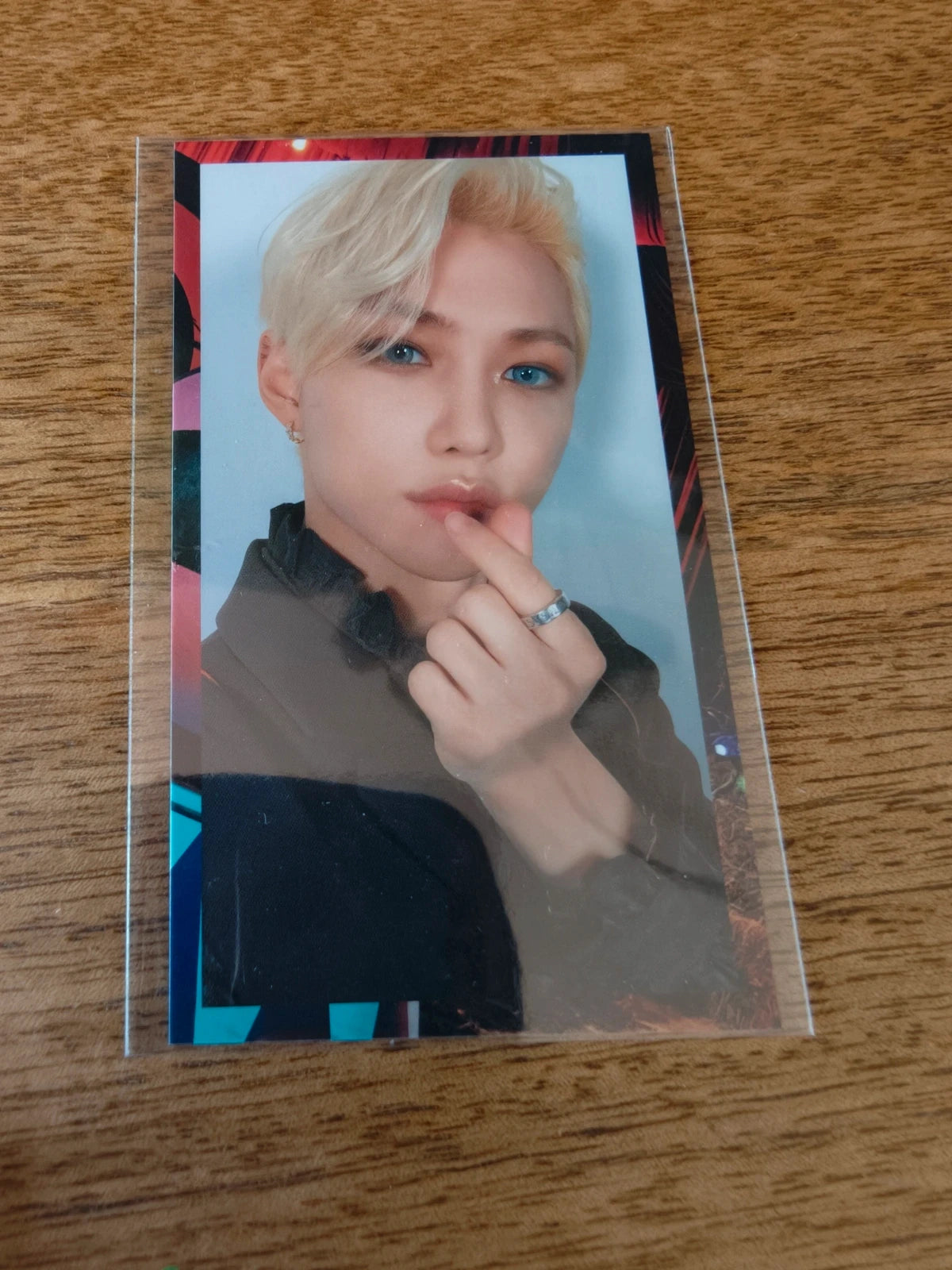 Stray Kids Circus Photocard Felix, blond portrait with finger-heart pose