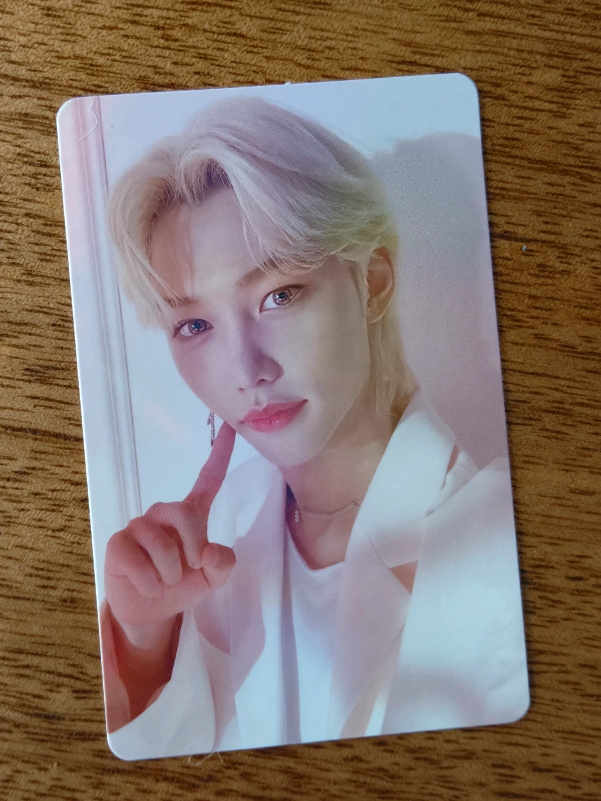 Stray Kids Felix Photocard NACIFIC, blond portrait in a white shirt with finger by cheek