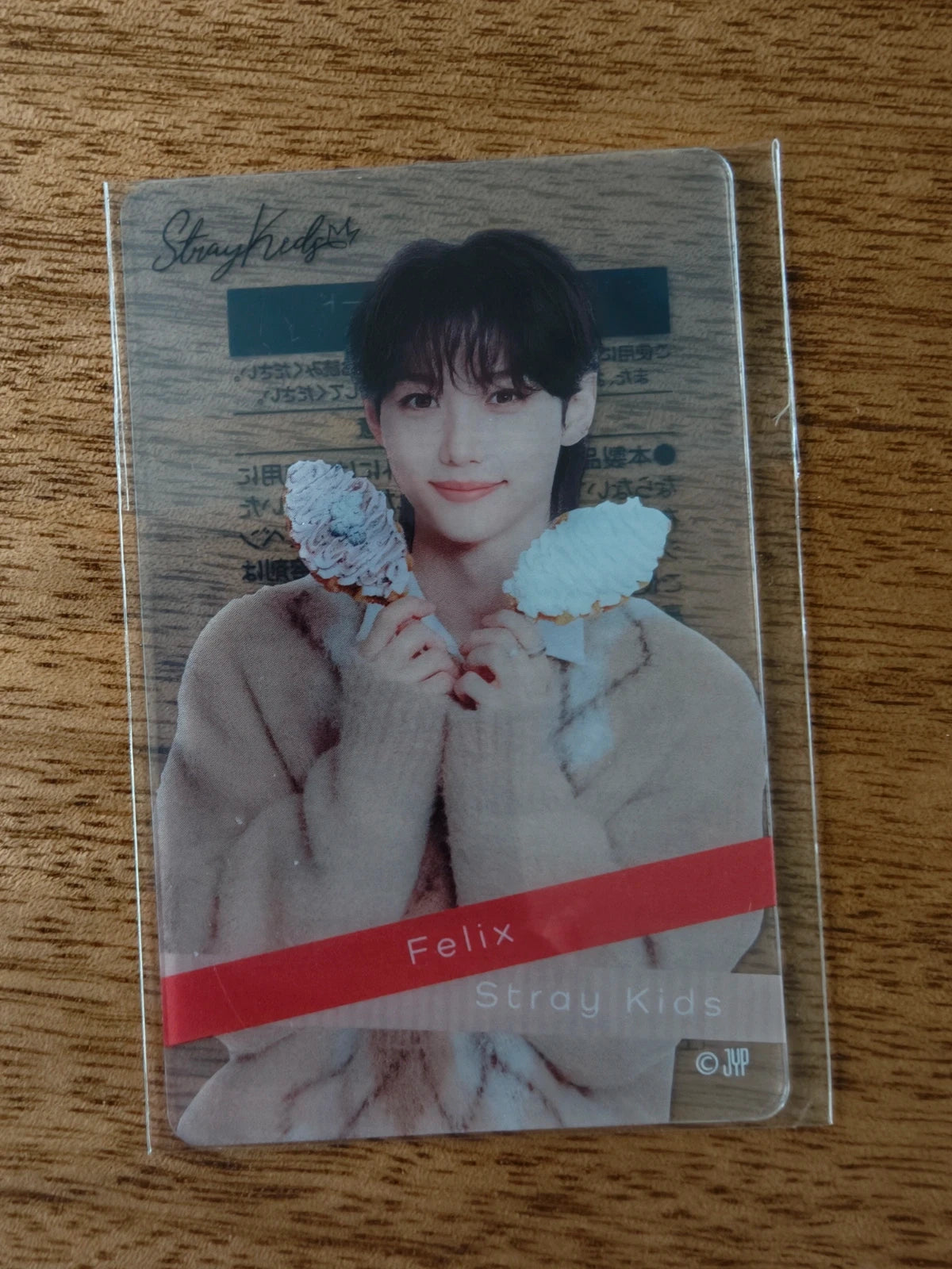 Stray Kids Felix Photocard, portrait wearing a beige coat with blue plush characters