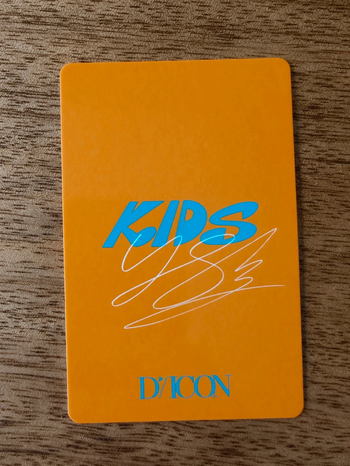 Stray Kids Felix Photocard DICON, orange reverse with blue KIDS lettering