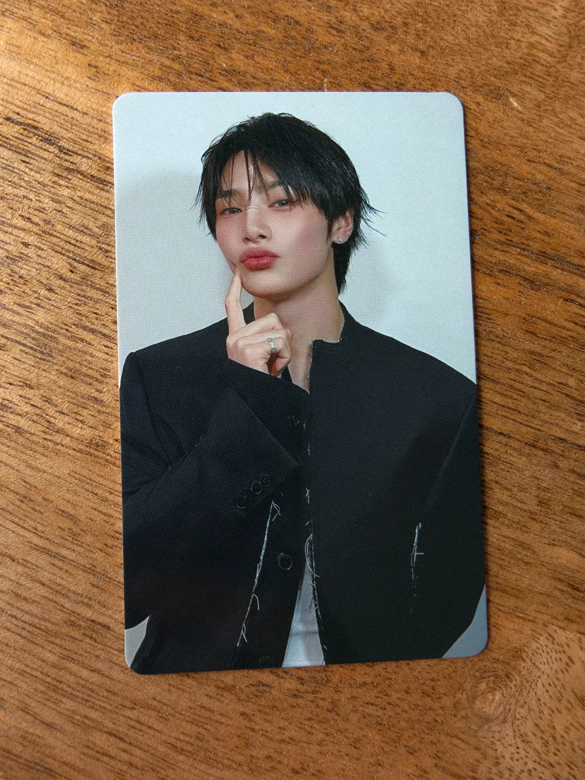 Stray Kids I.N Photocard KARMA HMV POB, portrait in a black jacket with finger by chin
