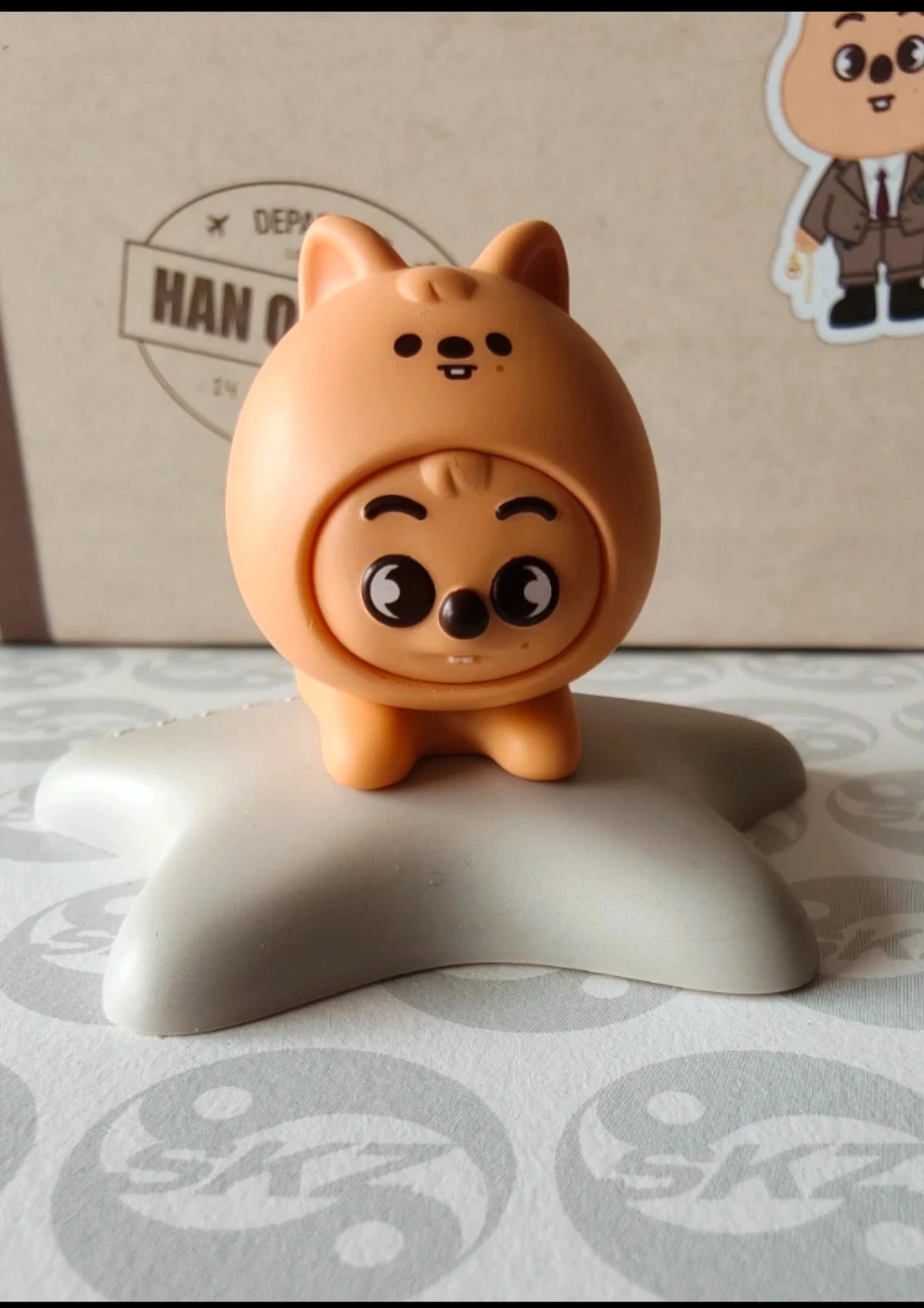 Stray Kids Han Quokka Figurine, orange hooded figure on a grey base
