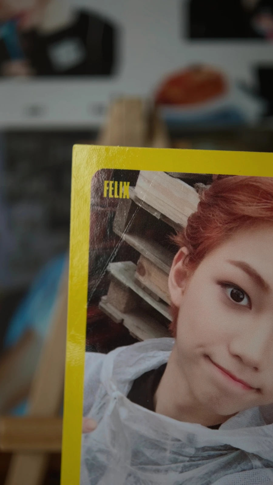 Stray Kids Felix I am WHO Photocard, angled close-up of the yellow-bordered portrait